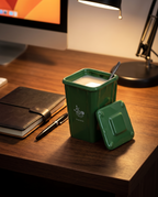 Trash can mug on a dark wood desk