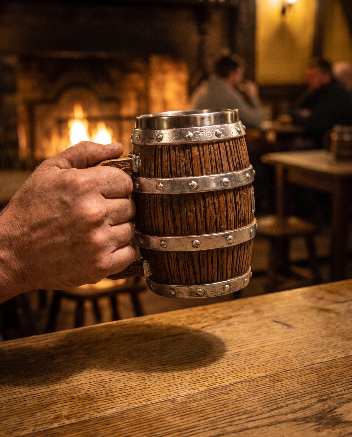 Hand lifting the barrel tankard off an oak bar